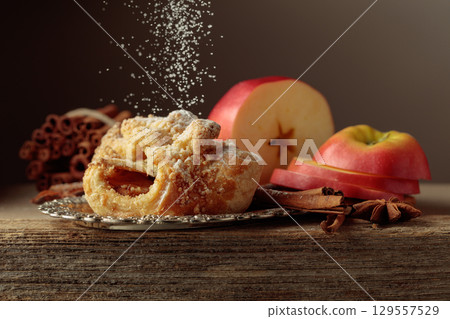 Viennese strudel with apple and cinnamon on old wooden table. 129557529