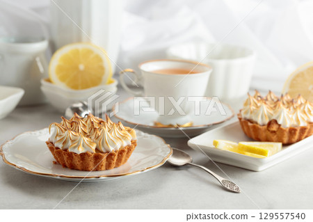 Meringue lemon tart on a white table. 129557540