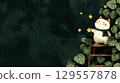Whimsical cat reaches for stars on ladder in leafy night garden 129557878