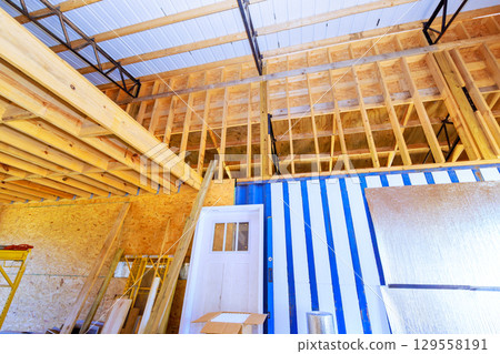 Interior view construction site showing wooden framing storage area in progress building 129558191
