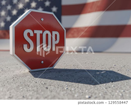 Stop sign in front of American flag, symbolizing national boundaries 129558447