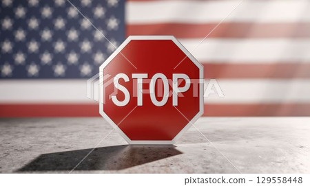Stop sign with American flag blurred in background 129558448