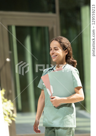 Female doctor in a green lab coat looking confident and contented 129559213