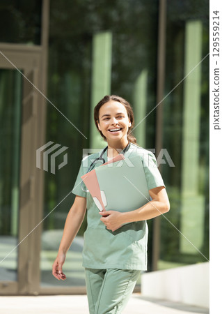 Female doctor in a green lab coat looking confident and contented 129559214