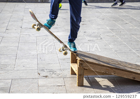 sports legs standing on a skateboard sports legs standing on a skateboard 129559237