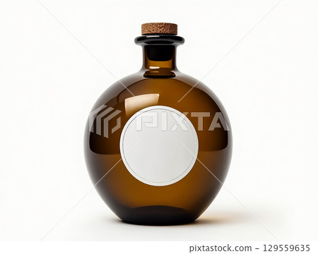 Elegant amber glass bottle with a cork top and blank label for custom branding or gifts 129559635
