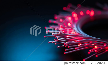 Fiber optic cables illuminated with red lights create a stunning visual effect in a dark setting 129559651
