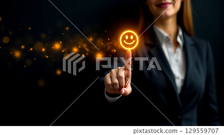 Professional woman using touch screen to display glowing smiley face in a dark environment during evening hours Professional woman using touch screen to display glowing smiley face in a dark environment during evening hours 129559707