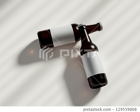Bottles with blank labels arranged on a surface creating interesting shadows in natural light 129559808