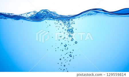 Bubbles rising through clear blue water highlighting a serene underwater view at midday 129559814