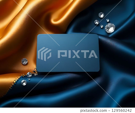 Elegant display of blank card on luxurious golden and blue satin fabric with sparkling gems Elegant display of blank card on luxurious golden and blue satin fabric with sparkling gems 129560242