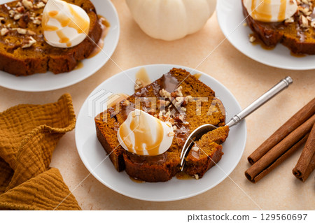 Pumpkin bread freshly baked topped with whipped cream, Thanksgiving dessert 129560697