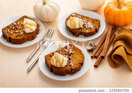 Pumpkin bread freshly baked topped with whipped cream, Thanksgiving dessert 129560700