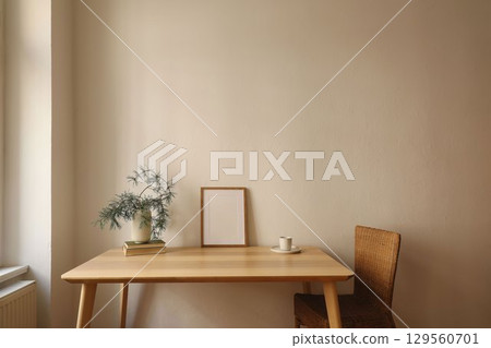 Christmas interior decor. Elegant scandinavian winter home. Blank vertical wooden picture frame mockup, cup of coffee, tea. Table, rattan chair at window. Pine tree branches, vase. Wall background 129560701