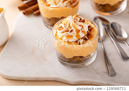 Pumpkin cheesecake in a glass, fall dessert idea, no bake Thanksgiving dessert 129560711