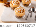 Pumpkin dessert in a cup, pudding or no bake cheesecake with spices and whipped cream 129560717