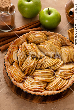 French apple pie or tart with apple slices arranged on top French apple pie or tart with apple slices arranged on top 129560721