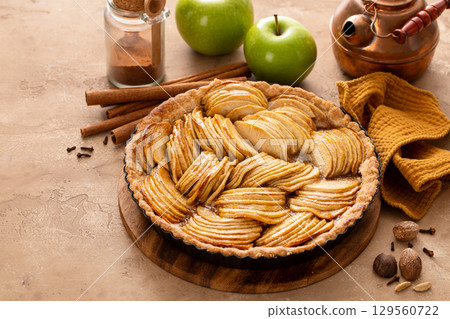 French apple pie or tart with apple slices arranged on top French apple pie or tart with apple slices arranged on top 129560722