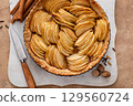 French apple pie or tart with apple slices arranged on top 129560724