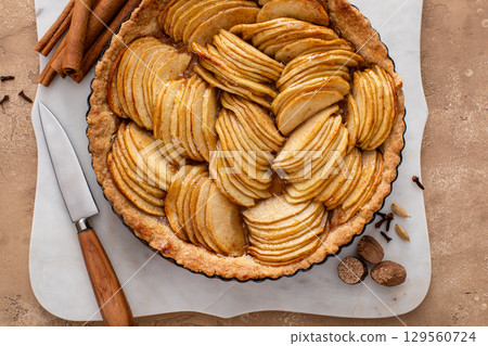 French apple pie or tart with apple slices arranged on top French apple pie or tart with apple slices arranged on top 129560724