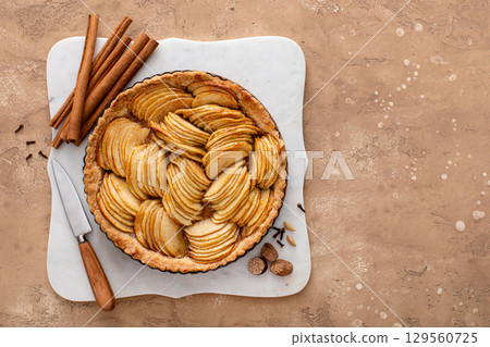 French apple pie or tart with apple slices arranged on top French apple pie or tart with apple slices arranged on top 129560725