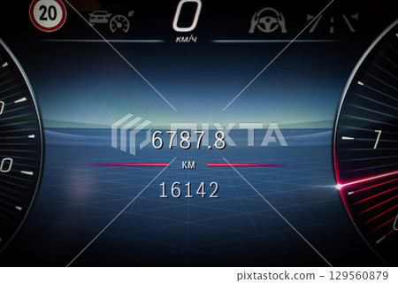 Digital car dashboard with odometer at 16142 km, trip at 6787.8 km, and speedometer at 0 km or h. Features include speed limits and cruise control. 129560879