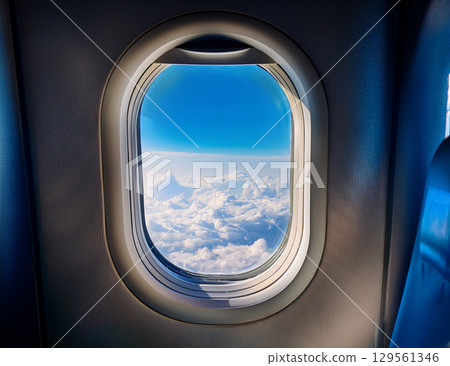 Blue sky and clouds seen from the airplane window 129561346