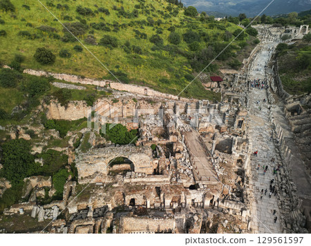 Curetes Street of ancient Ephesus with excavations and green hills, Turkey 129561597