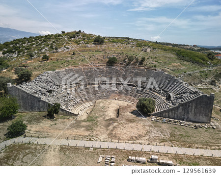 Grand stone tiers of miletus ancient theatre under blue summer sky, Turkey 129561639