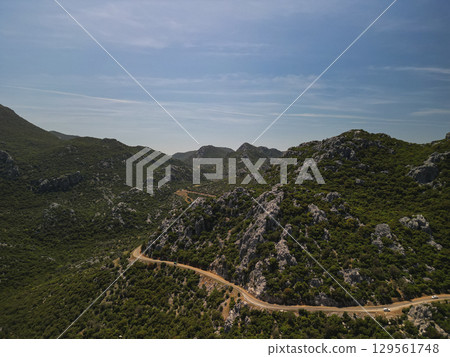 Aerial view of winding coastal road in Bozburun peninsula, Turkiye at midday 129561748
