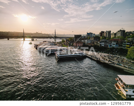 Golden Horn sunset with moored ferries and Halic Metro Bridge, Istanbul, Turkey Golden Horn sunset with moored ferries and Halic Metro Bridge, Istanbul, Turkey 129561779