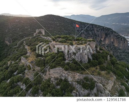 Aerial view Turkish flag over mountain citadel at Tlos near Fethiye, Turkiye 129561786