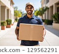 A man with a smile carrying baggage 129562291