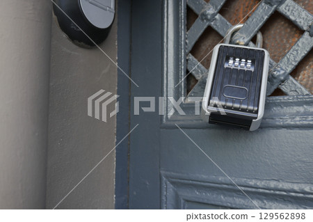 Lockbox mounted on an entrance door for secure access Lockbox mounted on an entrance door for secure access 129562898