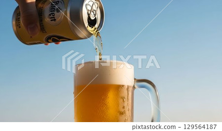 Under the summer sky: The moment a can of beer is poured into a mug 1 AI-generated image 129564187