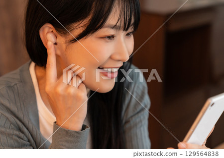 觀看在智能手機的婦女錄影 觀看在智能手機的婦女錄影 129564838