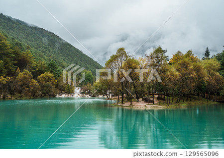Misty Autumn Lake and Waterfall in Blue Moon Valley, Lijiang, China 129565096