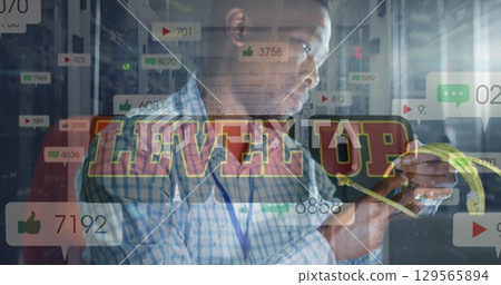 Image of level up text and falling icons african american worker 129565894