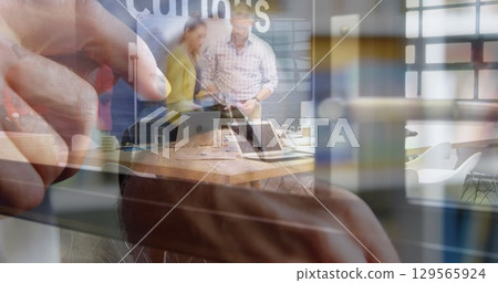 Image of person using smartwatch over group of business people 129565924