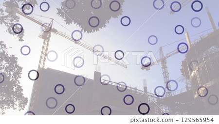 Image of falling circles over construction site 129565954