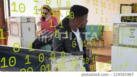 Image of data processing over two diverse people refueling car 129565967