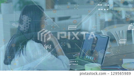 Image of icons and dna over woman having image call on laptop 129565989