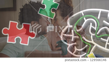 Image of colourful puzzle over couple with tablet Image of colourful puzzle over couple with tablet 129566146