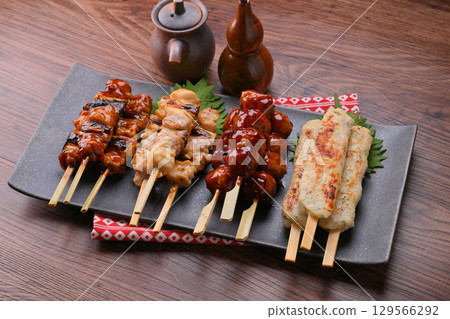 Assorted yakitori, negima, meatballs, salt, and sauce. 129566292