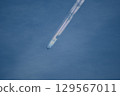 Blue sky and vapor contrails 129567011