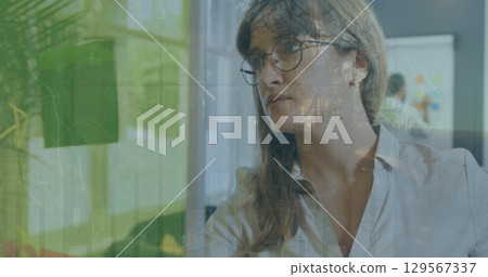 Image of data processing over caucasian businesswoman in office Image of data processing over caucasian businesswoman in office 129567337