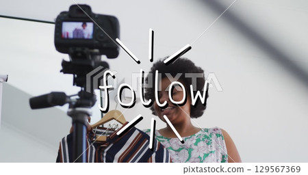 Image of follow text over african american woman trying on clothes, making vlog using camera 129567369