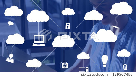 Image of clouds with icons over caucasian woman using laptop 129567493
