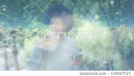 Image of clouds over african american businesswoman walking Image of clouds over african american businesswoman walking 129567525
