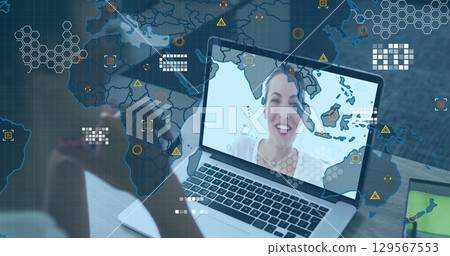 Image of world map and icons over african american woman having image call on laptop 129567553